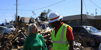 Joseph Rodrigues from Mobile District talks with a homeowner about the damage to her home.