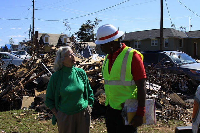 Joseph Rodrigues from Mobile District talks with a homeowner about the damage to her home.