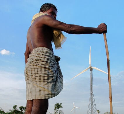 man standing in front of wind turbine