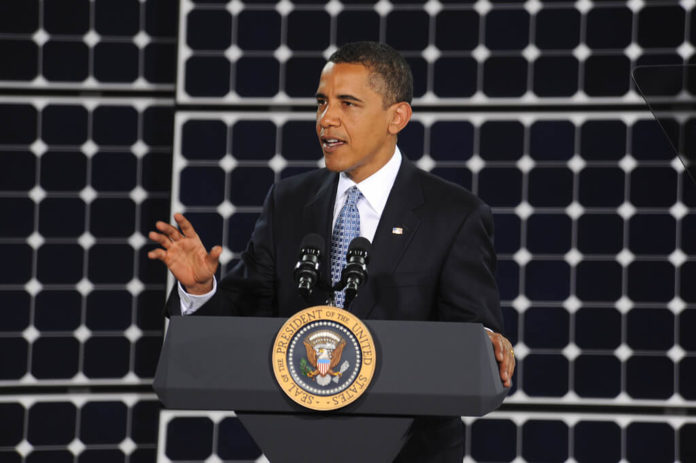 President Obama in front of solar panels President Obama in front of solar panels