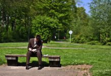 businessman sitting on park bench