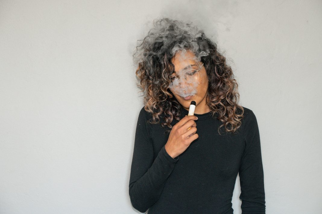 woman using nicotine vape