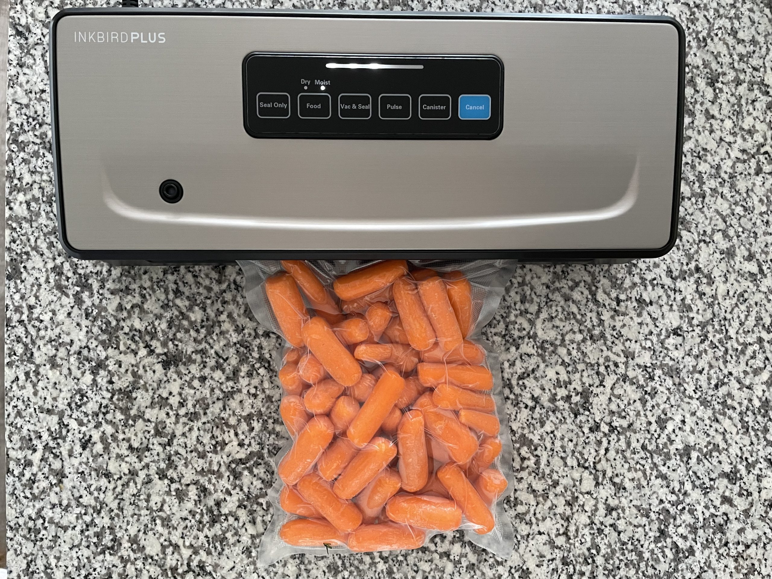 INKBIRD plus vacuum sealer and a bag of sealed carrots