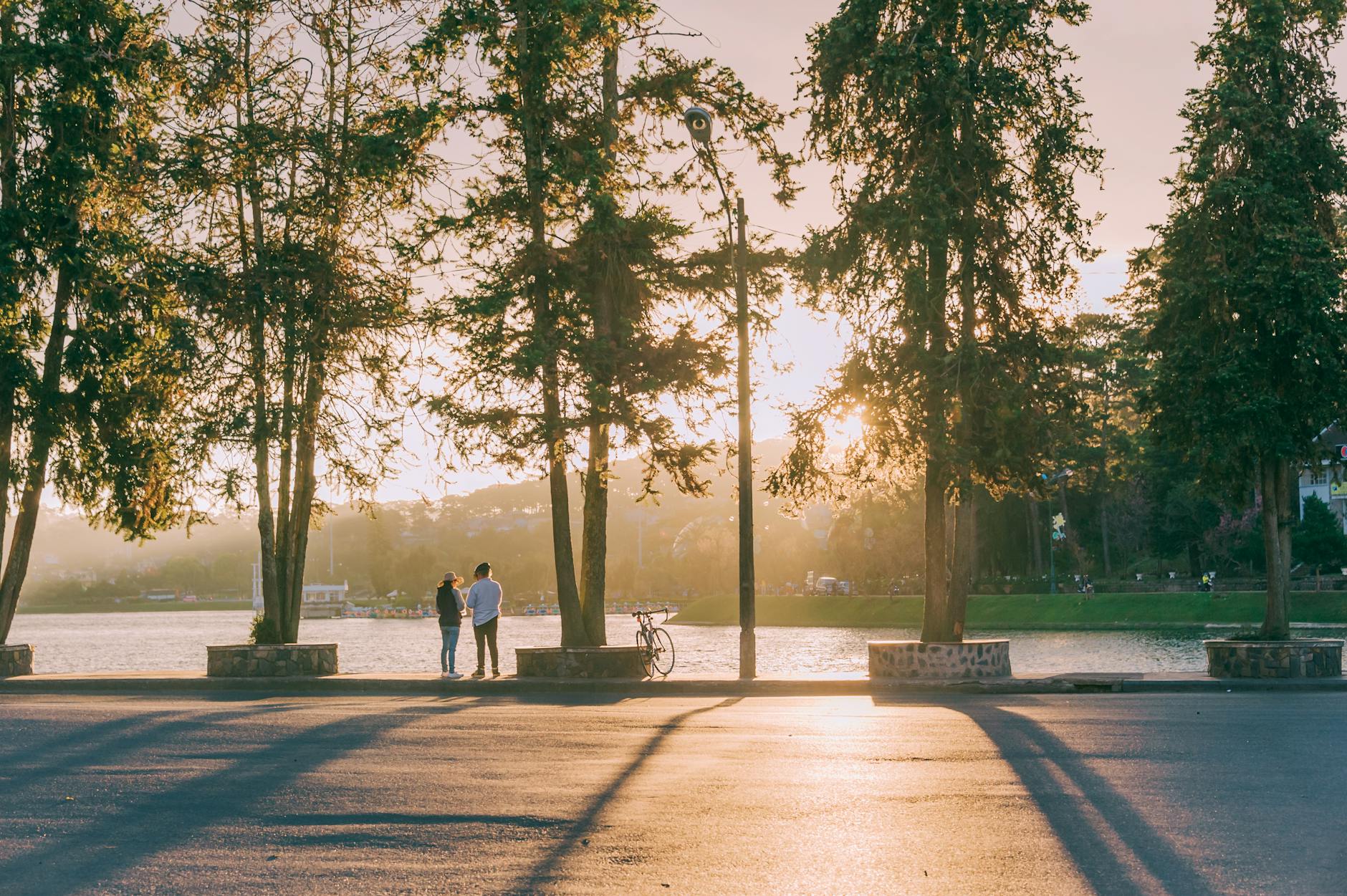 two people standing near body of water