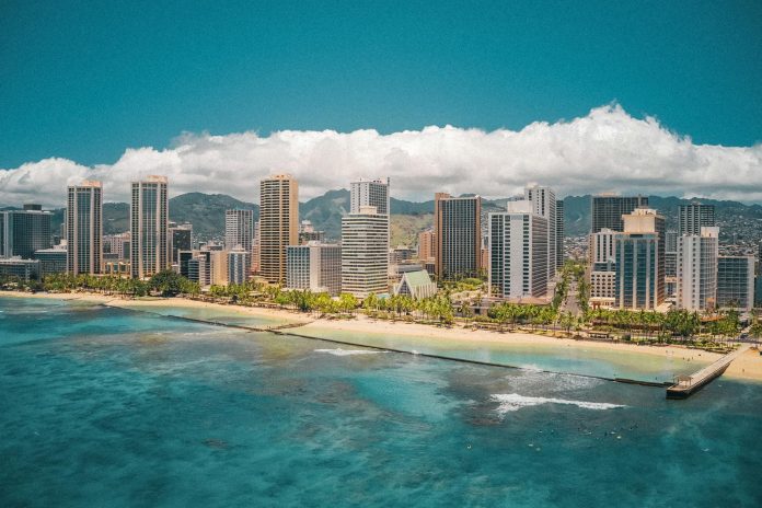high rise buildings near sea under blue sky