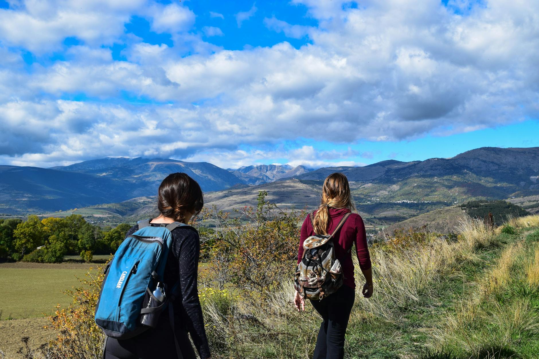 two women walks to open field