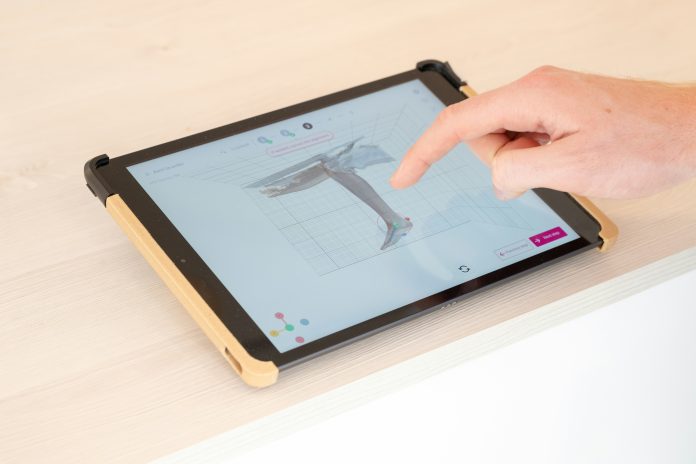 person pointing on tablet of orthopedic procedure