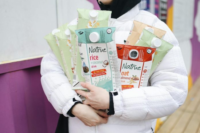 person holding milk carton